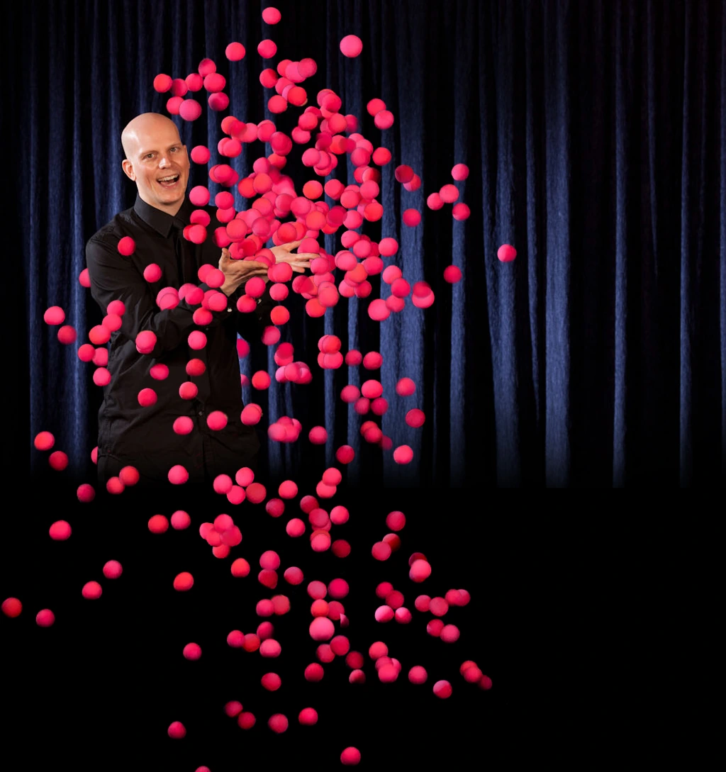 Florian Severin surrounded by flying red balls